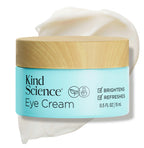Kind Science Eye Cream jar with wooden cap on a white background with a swatch of the product