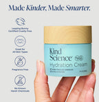 Kind Science Hydration Cream jar held by a hand with product features listed on a light gray background.