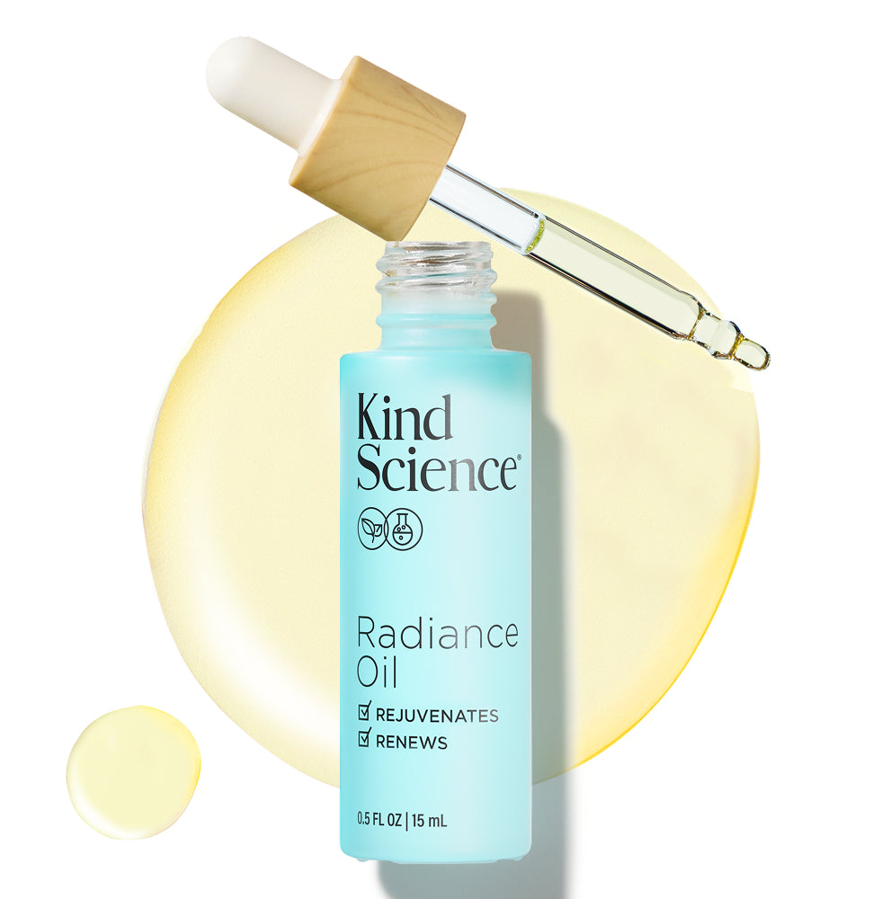 Kind Science Radiance Oil bottle with dropper on a white background with a swatch of the product