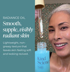 Woman with a bottle of Kind Science radiance oil against a patterned wall.