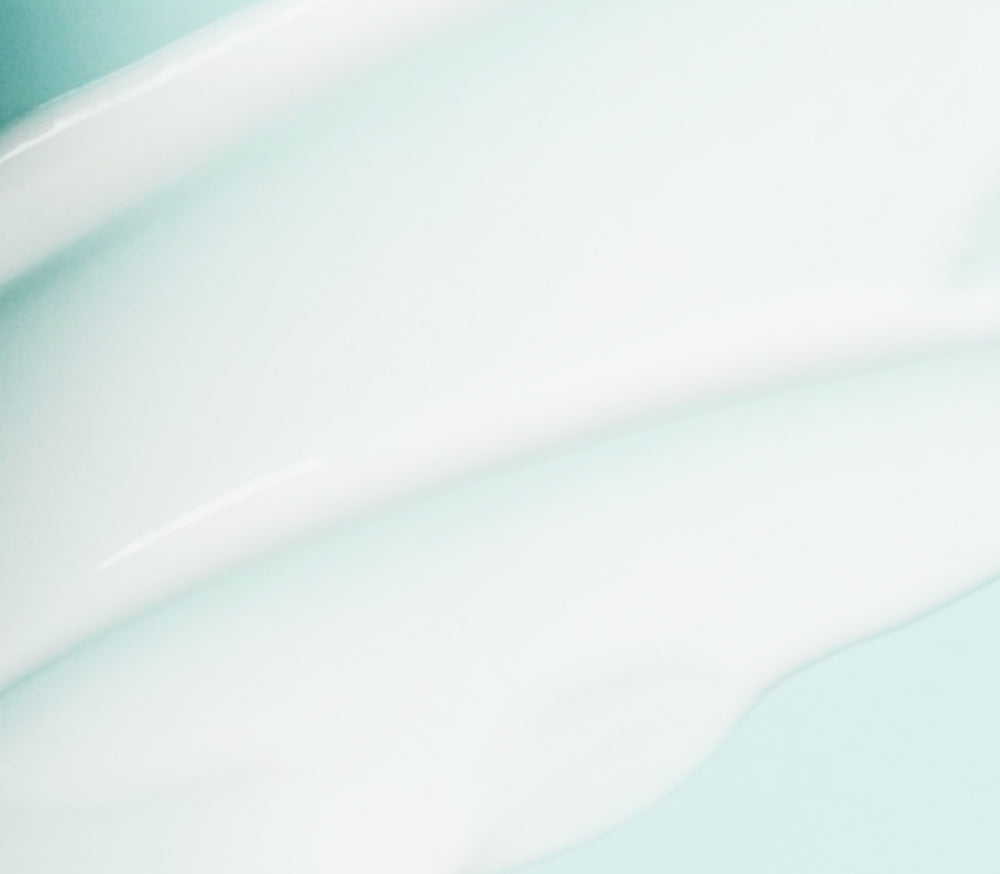 Close-up of firming serum on blue background 