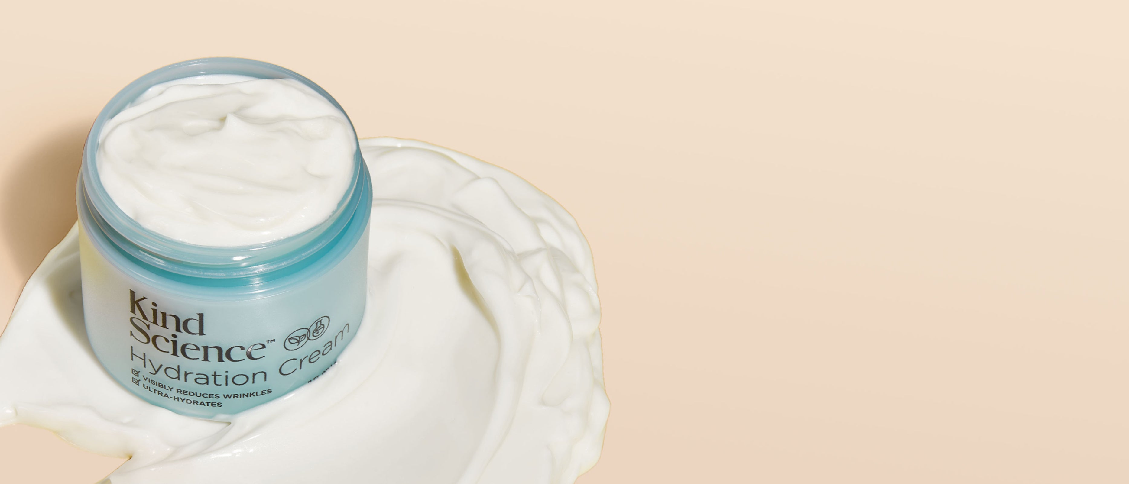 Jar of Kind Science Hydration Cream with cream on a beige background